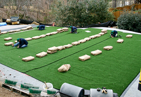 work in progress image of technicians working on backyard green installation
