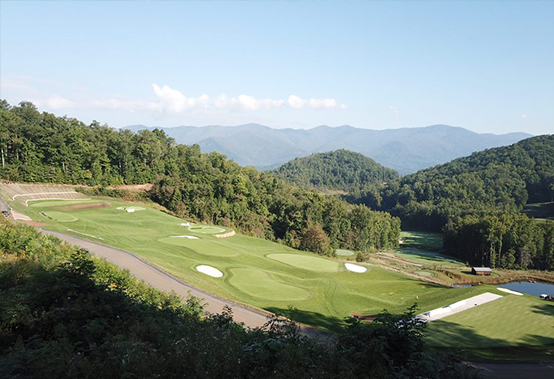 shot of putting green with mountains in far background